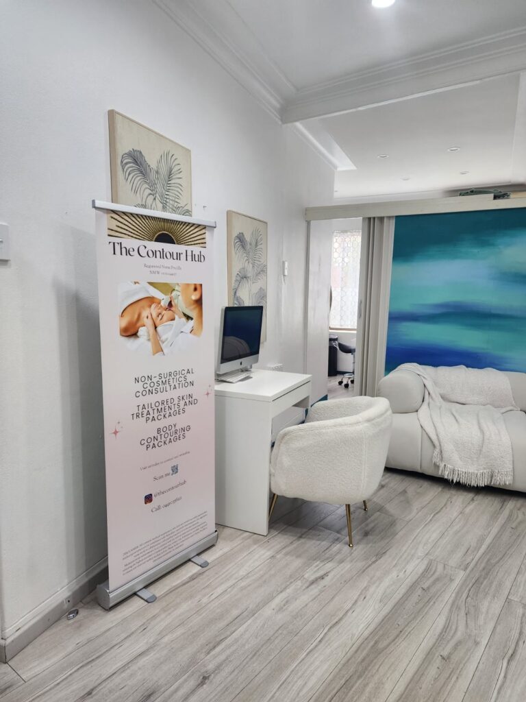 The Contour Hub Advanced Skin and Aesthetic Clinic private consultation desk and plush white chair.
