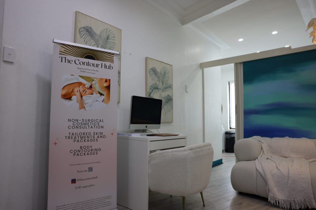 The Contour Hub Advanced Skin and Aesthetic Clinic private consultation desk and plush white chair in Auburn.